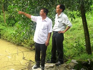 Cựu chiến binh Trần Thanh Duyên- Phó Chủ tịch HĐND xã Phúc Trạch bên mô hình VAC (Ảnh Văn Đình).